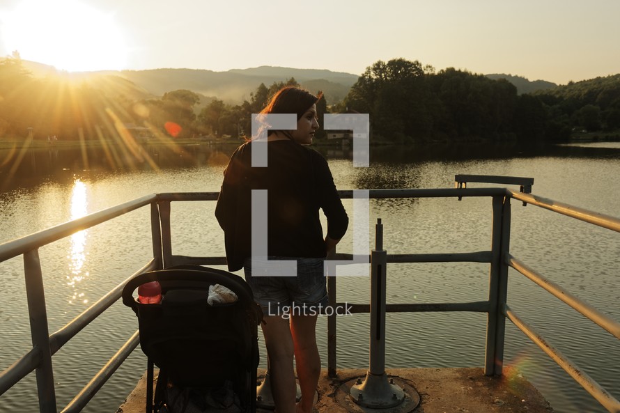 a mother and stroller on a dock 