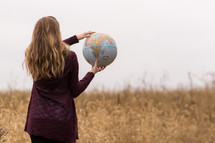 woman holding a globe 