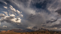 clouds over red rock peaks 