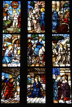 Stained glass windows in a church depicting stages of the life of Christ