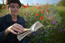 Woman In A Poppy Field Reading and Holding A Book