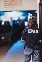 EMS staff standing in a doorway of a church 