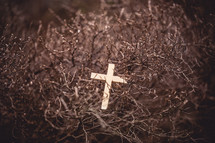 wood cross in a dry bush 