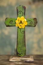 a green an yellow wooden cross 