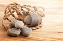 A Sling Shot and Stones on a Wooden Table from the Story of David and Goliath in the BIble 