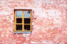 single window on a stucco wall 