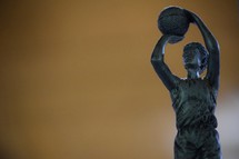 A basketball trophy against orange background 