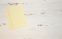 lined paper on white wood background 