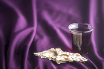 communion elements on purple fabric 