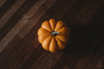 orange pumpkin on a wood table 