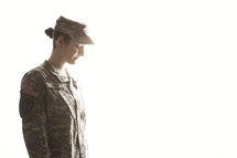 female soldier looking down in prayer 