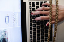hands tied to a computer keyboard 