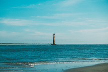 lighthouse and tide on a beach 