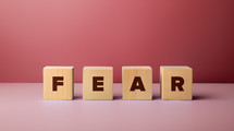 Wooden blocks with the word fear.