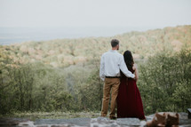 couple standing on a hillside 