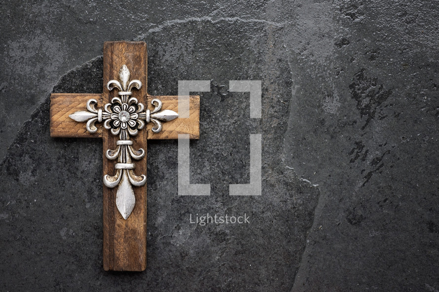 a decorative wooden cross with metallic details 