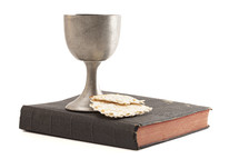 Holy Communion in a Pewter Goblet Isolated on a White Background