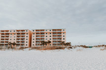 sand on a beach and hotels 