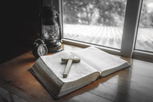alarm clock and Bible in a window 