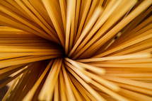 A pile of spaghetti dry on the table. Against a dark background. High quality photo