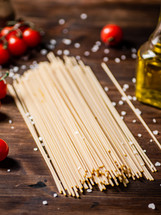 A pile of spaghetti dry on the table. Against a dark background. High quality photo