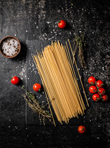 A pile of spaghetti dry on the table. Against a dark background. High quality photo