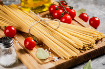 A pile of spaghetti dry on the table. Against a dark background. High quality photo