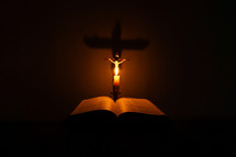 Candlelight photo of a Bible and crucifix