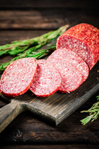 Delicious salami sausage on the table. On a black background. High quality photo