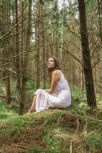 a young woman alone in a forest 