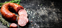 Delicious salami sausage on the table. On a black background. High quality photo