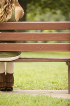 Woman sitting on a park bench.