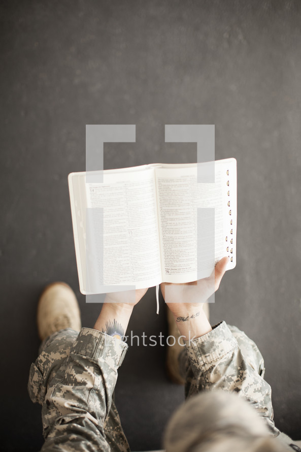 soldier reading a Bible 