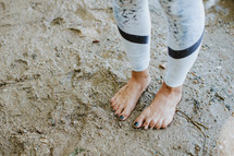 barefoot in wet sand 