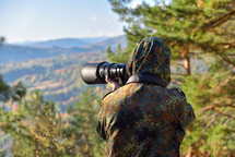 Wildlife photographer in camouflage