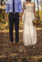 portrait of a bride and groom holding hands 