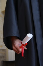 boy holding his diploma 
