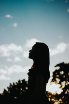 silhouette of a young woman at sunset 