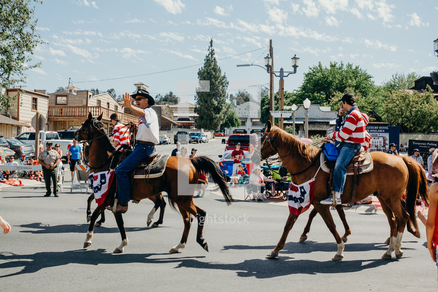 people riding horses in a parade