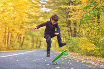 boy riding skateboard outdoors in autumn environment on sunset warm light