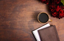 red hydrangeas, Bible, journal, and coffee cup on a wood table 