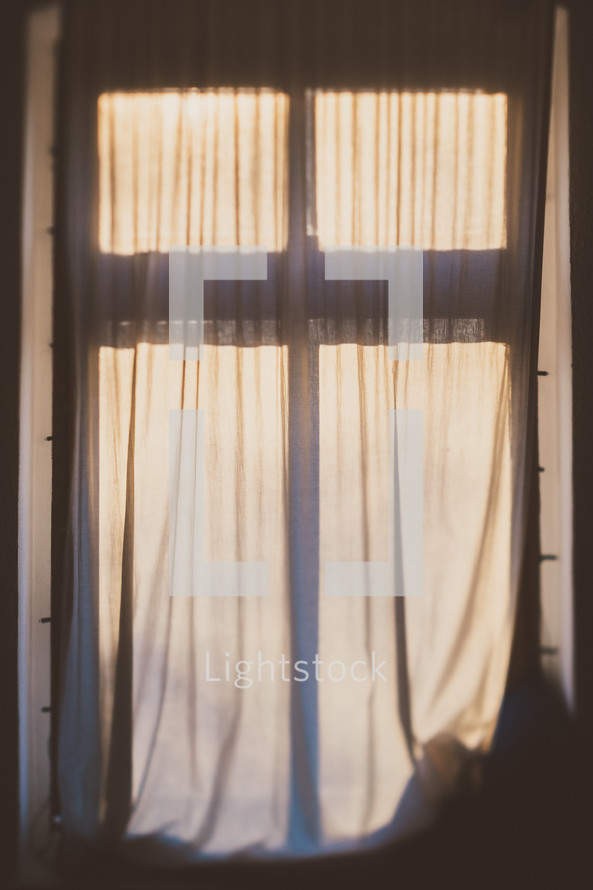 sunlight on curtains through a window 