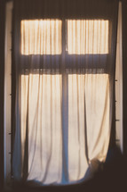 sunlight on curtains through a window 