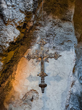 Crucifix hanging inside a Cave