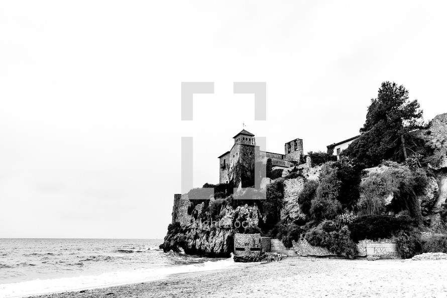house on a cliff along a shore in Spain 