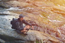 Nature professional photographer resting near a waterfall