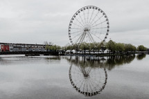 reflection of a ferris wheel on water 