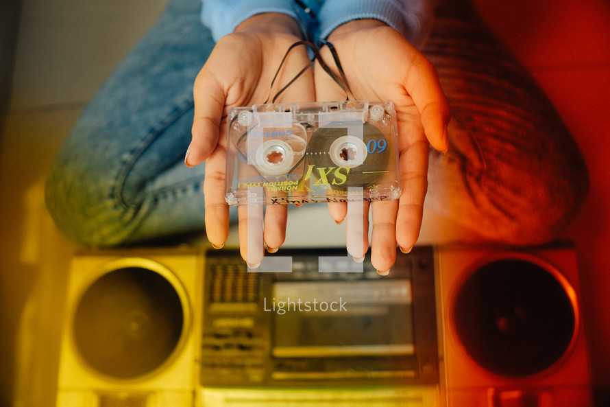 a woman holding a cassette tape 