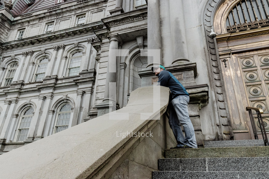 a man standing at the top of stone steps 