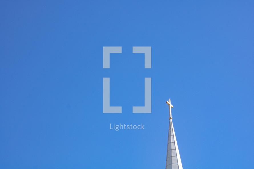 White steeple against bright blue sky background